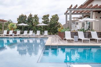 Two resort-style pools with lounging edges and cabanas